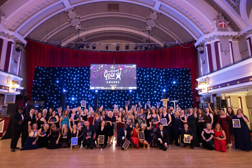 Group photo of all award winners together with their awards and trophies.