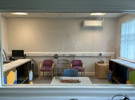Two chairs and a table inside the audiology room