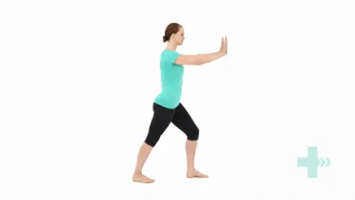 A moving image of a person standing with one foot in front of the other and leaning onto the forward foot and pushing against a wall