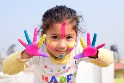 A young girl with hands painted