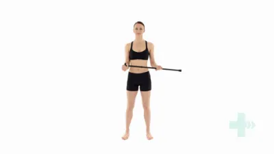Moving image of someone standing with a stick in their hands and using the stick to push their arm out to the side.