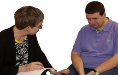 A man looking sad whilst speaking to a woman
