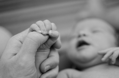 Baby holding finger